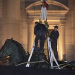 The part of the statue, with Theodore's legs on the horse, with the Native American and African man on either side, is removed with a crane from the front of the American Museum of Natural History